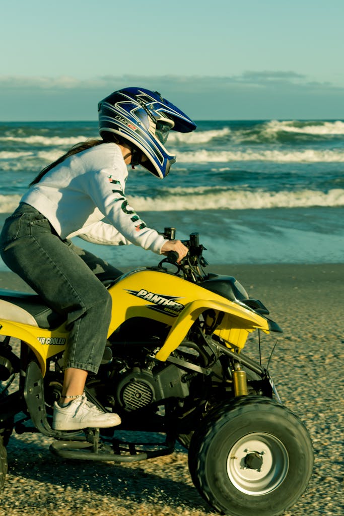 A Person in Denim Pants and White Sweater Riding an Atv