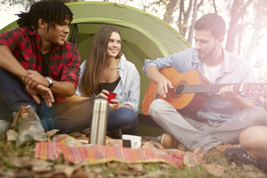 A Photo of a Man Strumming on Acoustic Guitar