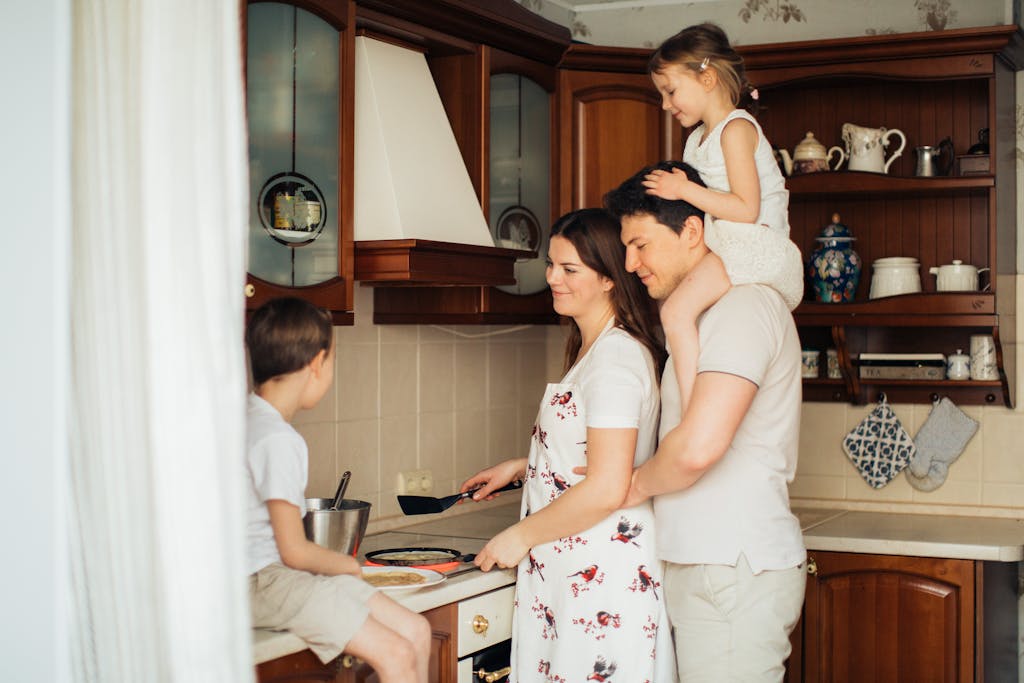 Photo of Woman Cooking Near Her Family